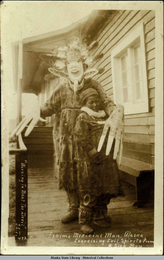 Eskimo medicine man, Alaska, exorcising evil spirits from a sick boy (The Library of Congress)